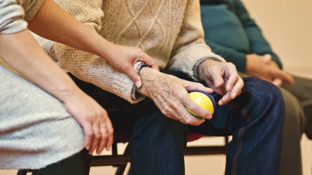 Accompagnement d’une personne âgée avec exercice de balle thérapeutique